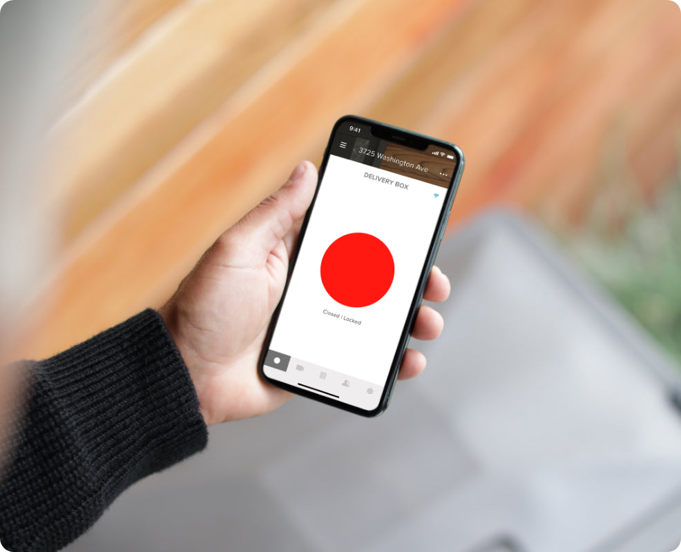 A man showing his locked status of his smart delivery box n the August app