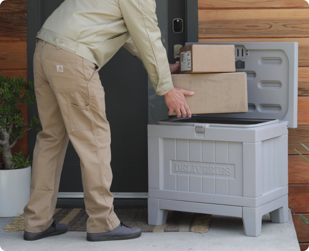 A mailman putting packages in a delivery smartbox