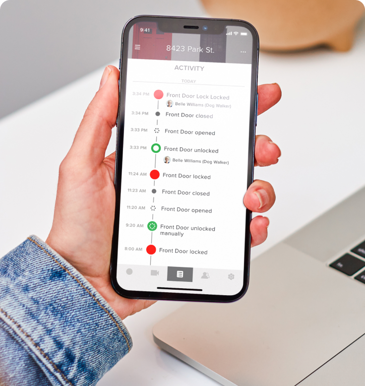 A smartphone showing the door activity log on the August app