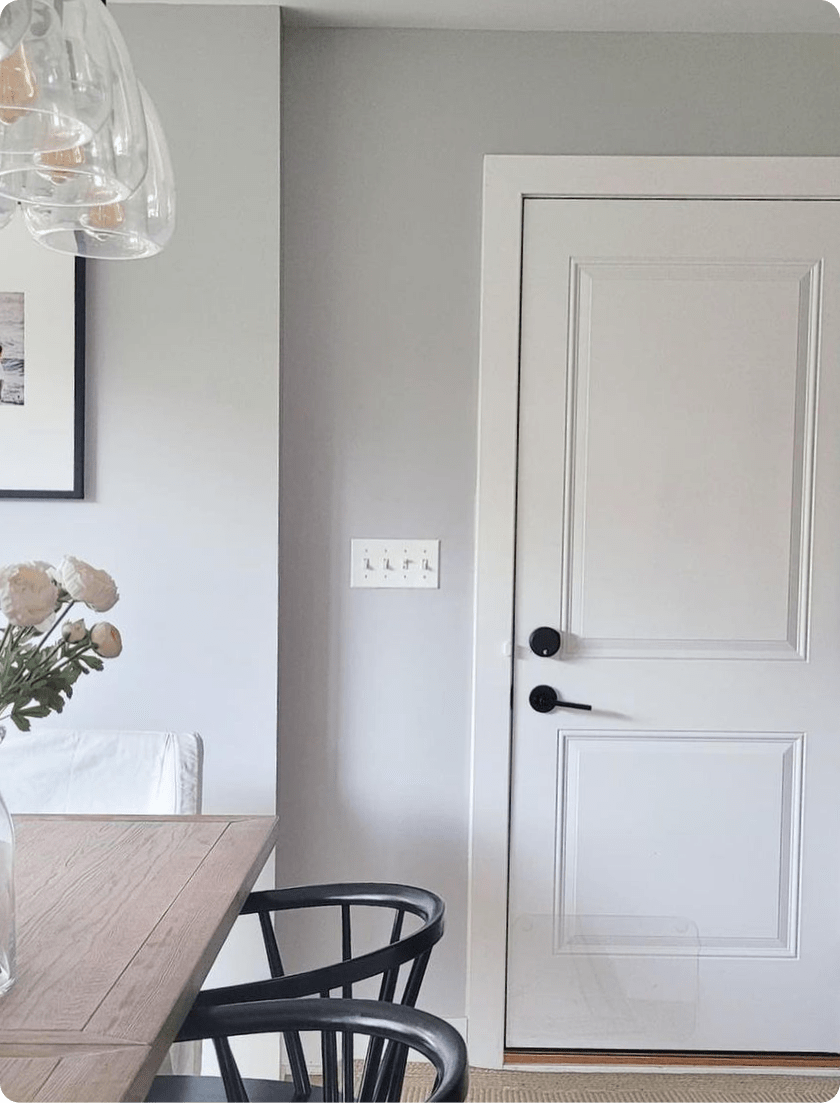 Dining room table and front door seen with an August smart lock 