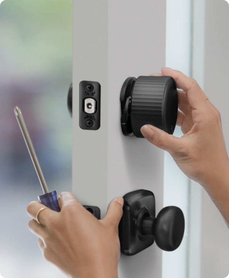 Woman installing her August smart lock