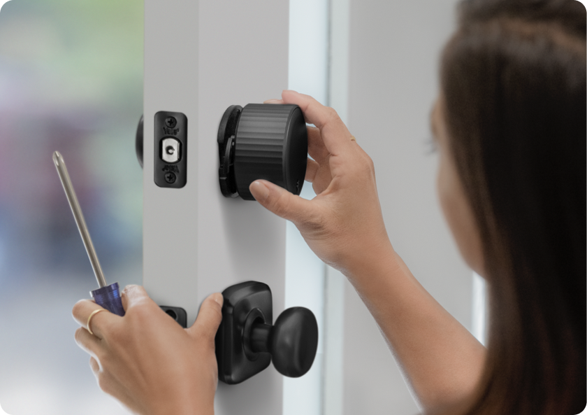 Woman installing her August smart lock